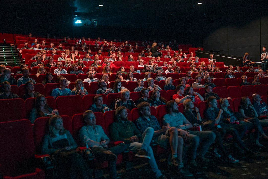 Audience watching a movie on a cinema screen